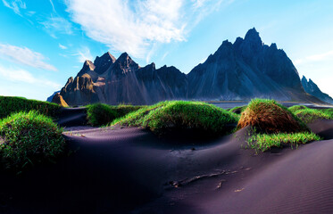 Vestrahorn Scenic landscape with most beautiful mountains Vestrahorn on the Stokksnes peninsula and cozy lagoon at sunset in Iceland. Exotic countries. Amazing places.