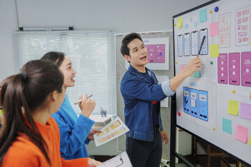 Group of young Asian ui and ux designers working on user interface and experience for mobile...
