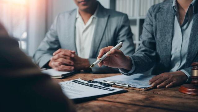 Business people and lawyers engaging in contract assessment discussions during a professional meeting in an office setting