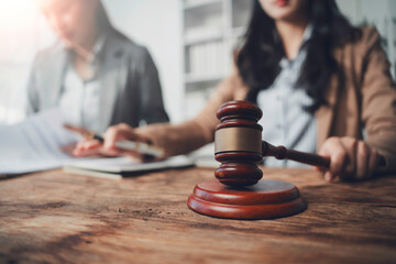 Judge holding a gavel while engaging in a legal consultation with a client about an ongoing lawsuit...