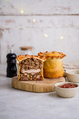 English pie with three types of meat, nuts, spices.