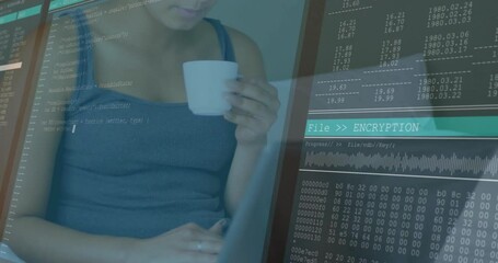 Woman holding mug and typing on laptop while initiating data encryption with animated code overlay - Powered by Adobe