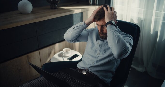 Stressed Financial Analyst Monitoring Exchange Market Charts and Real-Time Stocks Falling on Laptop, Soaking Financial Loss. Investment Agent Depressed About Bad Economy News, Stock Market Crash.