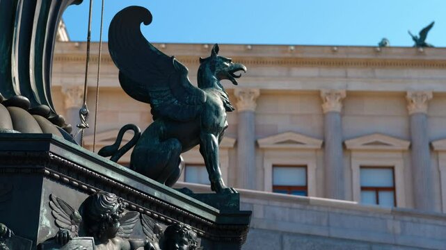 Griffin statue guarding austrian parliament building in vienna. Majestic griffin statue standing guard over austrian parliament building, symbolizing power and vigilance against blue sky backdrop