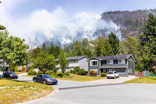 Neighborhood with Active Forest Fire in Squamish, BC, Canada and Smoke Rising
