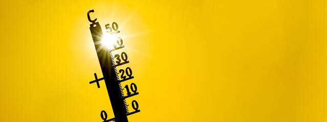 Hot weather, global climate change concept - Heat wave / Summer heat temperature celsius background banner long - Thermometer yellow orange sky and sun rays