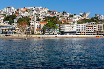 Fototapeta premium Ulcinj city waterfront with beach, mosque and colorful hillside buildings viewed from Adriatic Sea, Montenegro