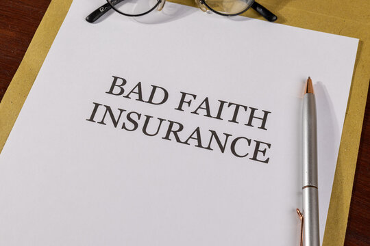 Legal Paper Titled &lsquo;Bad Faith Insurance&rsquo; Placed on Envelope with Pen &ndash; Insurance Law Concept