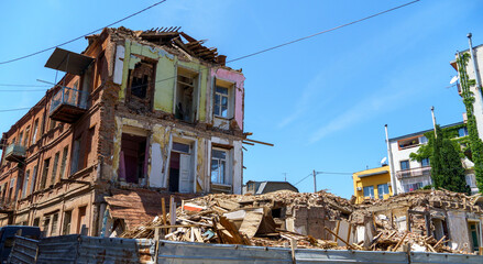 Fototapeta premium Destroyed houses in the old city of Tbilisi, Georgia for modernization development on tourism. Demolition of old buildings.