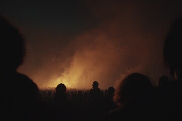 Crowd enjoying a vibrant festival experience illuminated by fireworks in a night sky
