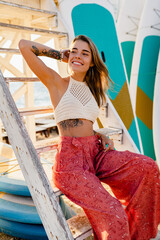 beautifil blond woman posing on summer beach in sunny weather