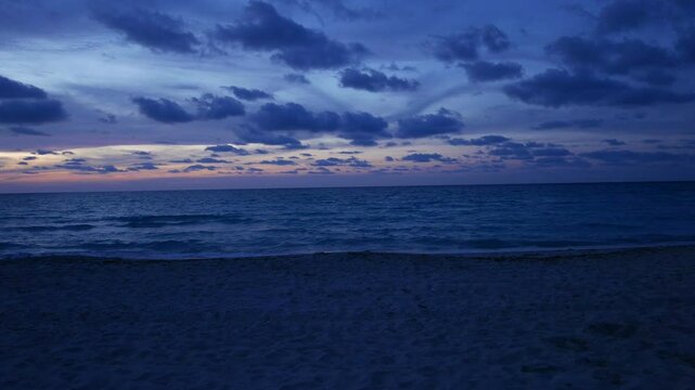 Early evening dusk sunset shot of a tropical Caribbean beach in Varadero, Cuba.  Panning shot.