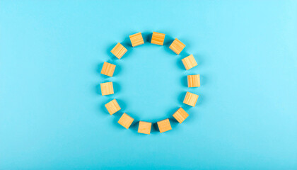 Wooden Blocks Forming Circle on Blue
