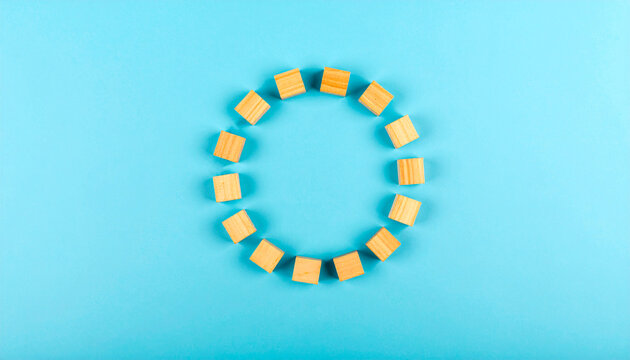 Wooden Blocks Forming Circle on Blue