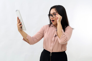 Asian business woman surprised touching glasses, looking at computer digital tablet screen held,...