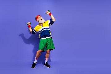 Cheerful man exercising with dumbbells wearing colorful retro activewear, embodying a vibrant old school sports style