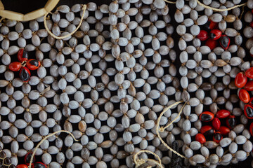 organic Amazonian crafts adorned with huayruro seeds(Ormosia coccinea)  . Symbols of luck, protection, and the deep connection between nature and culture in the rainforest. Iquitos Peru.