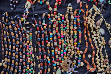 Obraz premium organic Amazonian crafts adorned with huayruro seeds(Ormosia coccinea) . Symbols of luck, protection, and the deep connection between nature and culture in the rainforest. Iquitos Peru.