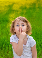 The child points with his hand quietly. Selective focus.