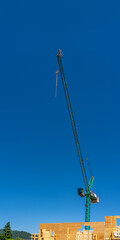 Modern apartment building under construction. The site with crane in Vancouver, Canada, North America. Day time on May 2025.