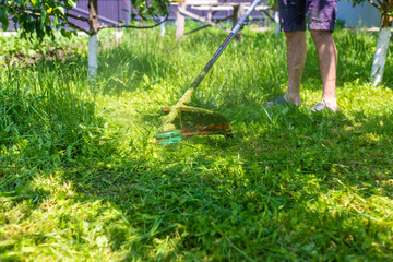 mow the grass in the garden. Selective focus.