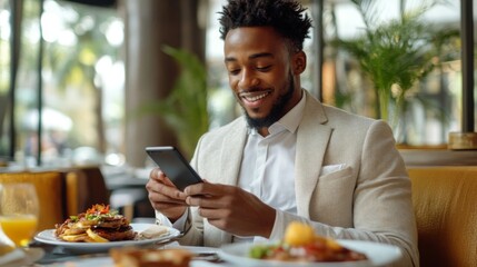 Smiling Man Using Smartphone at Restaurant Breakfast
