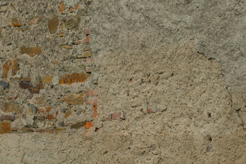 The image captures a wall that is adorned with a diverse array of textures and materials such as bricks and plaster, showcasing an intriguing mix of various architectural styles and designs