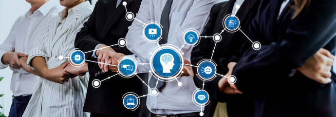 A diverse team of professionals engages in dynamic collaboration, exploring artificial intelligence concepts represented by digital icons in a modern workplace setting. Amity