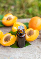 Apricot essential oil in a bottle. Selective focus.