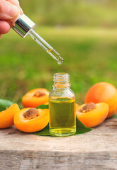 Apricot essential oil in a bottle. Selective focus.