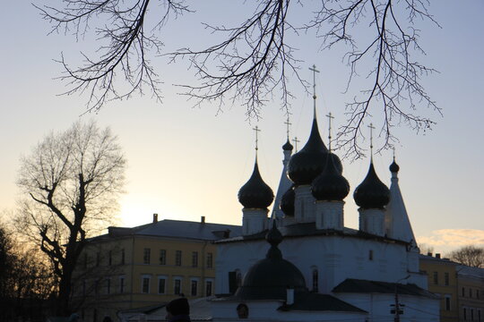Yaroslavl, RUSSIA - aprel 9, 2025: sunset near the orthodox church and trees siluets