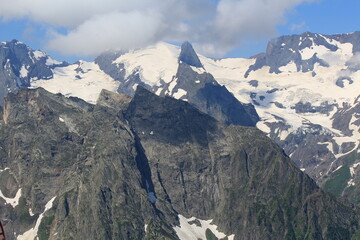 mountain peaks of elbrus region in dombai in midsummer