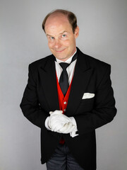 Butler or Hotel Concierge in Formal Attire and White Gloves Eager to Be of Service. Professional Hospitality and Courtesy.