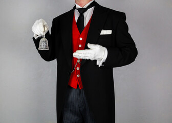 Butler or Hotel Concierge in Formal Attire Holding Bell. Ring for Service. Professional Hospitality and Courtesy.