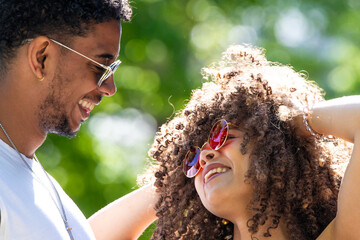 young latin couple smiling happily, laughing