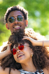 young latin couple smiling happily, laughing