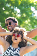 young latin couple smiling happily, laughing