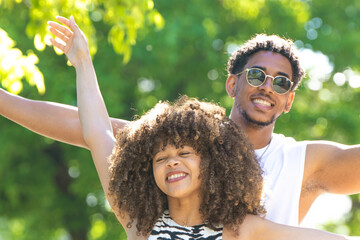young latin couple smiling happily, laughing
