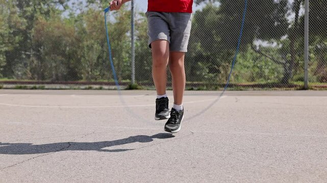 10 year old boy jumping rope at a park in Los Angeles. Slow Motion