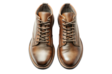Stylish overhead view of a pair of brown leather boots against a black background