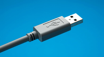 Close-up of a Grey USB Cable Connector Against a Blue Background