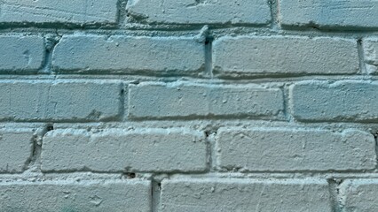 Close-up of a clean light blue painted brick wall. Smooth texture and even tone across the surface