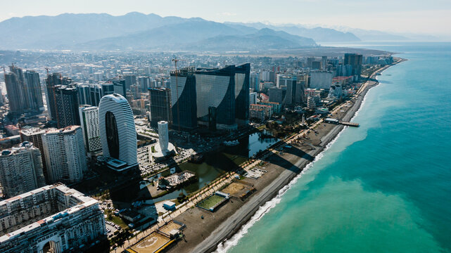Aerial perspective revealing batumi's vibrant cityscape, modern architecture spanning black sea coastline, georgia's urban landscape glowing with contemporary design