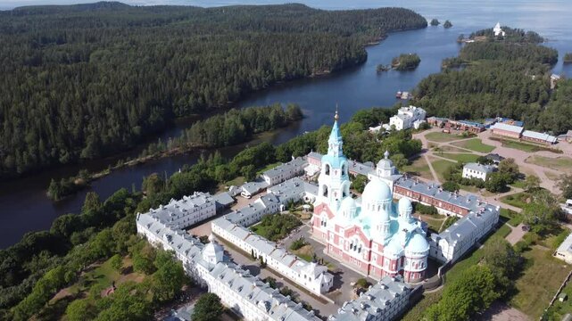 9-second 4K drone footage showing a smooth vertical ascent over Valaam Monastery in Karelia during summer, rising up to the horizon level