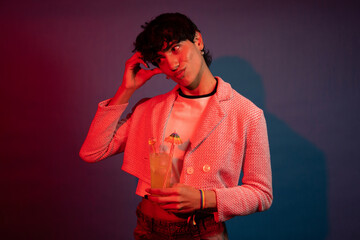 Stylish person enjoying a refreshing cocktail at a vibrant nightclub