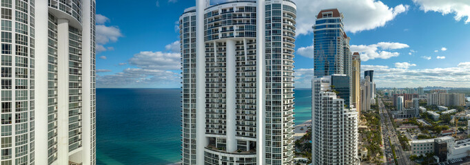 Sunny Isles Beach city with luxurious highrise hotels and condo buildings on Atlantic ocean shore....