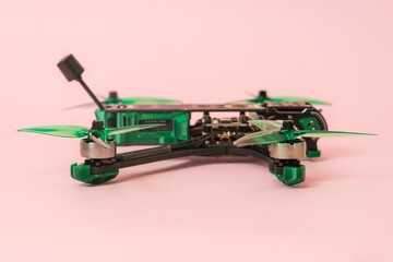 Close up view on modern drone with camera isolated on pink background
