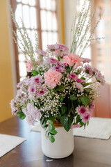 Elegant floral arrangement in soft pink and lavender hues, creating a serene and beautiful centerpiece.