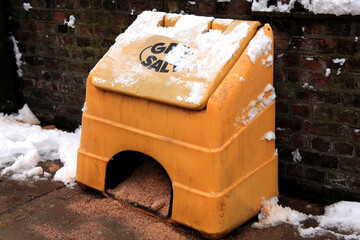 Plastic container of grit and salt for gritting road surfaces in snow blizzard and ice conditions,...