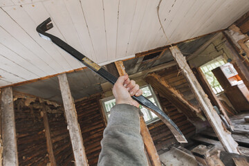 Expressive image of a construction worker using a crowbar